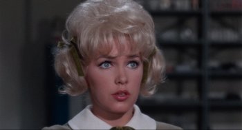 Movie still from “The Nutty Professor” (1963), directed by Jerry Lewis – A person with blonde hair and blue eyes; Close Up shot, Over the shoulder angle