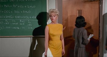 Movie still from “The Nutty Professor” (1963), directed by Jerry Lewis – A woman standing in front of a chalkboard; Medium shot, Over the shoulder angle