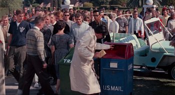 Movie still from “The Nutty Professor” (1963), directed by Jerry Lewis – A crowd of people standing around a mailbox; Medium shot, High angle