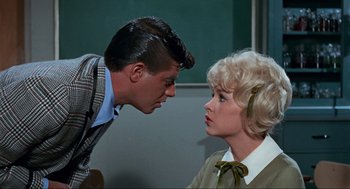 Movie still from “The Nutty Professor” (1963), directed by Jerry Lewis – A man and a woman face each other in front of a chalkboard; Medium shot, Over the shoulder angle