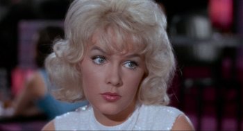 Movie still from “The Nutty Professor” (1963), directed by Jerry Lewis – A person with blonde hair; Close Up shot, Over the shoulder angle