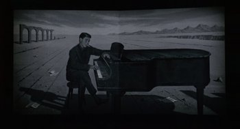 Movie still from “The Nutty Professor” (1963), directed by Jerry Lewis – A black and white photo of a man sitting at a piano; Wide shot, High angle