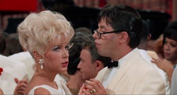Movie still from “The Nutty Professor” (1963), directed by Jerry Lewis – A man and a woman in a white dress and tuxedo; Close Up shot, Over the shoulder angle