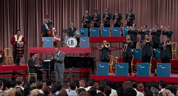 Movie still from “The Nutty Professor” (1963), directed by Jerry Lewis – A group of men in suits and ties performing on a stage; Extreme Wide shot, High angle