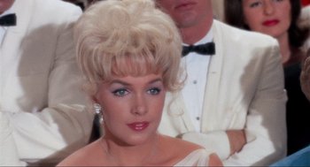 Movie still from “The Nutty Professor” (1963), directed by Jerry Lewis – A person wearing a dress; Close Up shot, Over the shoulder angle