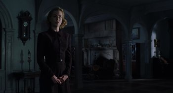 Movie still from “The Others” (2001), directed by Alejandro Amenábar – A woman standing in front of a fire place; Medium shot, Low angle