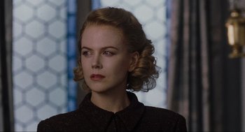 A woman in a black shirt is looking to her left