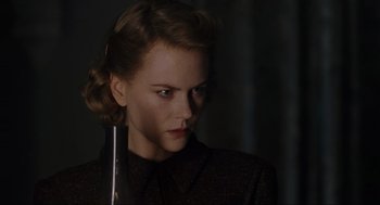Movie still from “The Others” (2001), directed by Alejandro Amenábar – A woman with a serious look on her face; Close Up shot, Over the shoulder angle