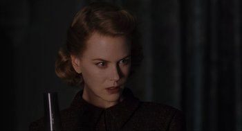 Movie still from “The Others” (2001), directed by Alejandro Amenábar – A woman in a dark room looking at the camera; Close Up shot, Low angle