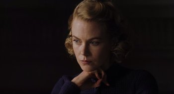 Movie still from “The Others” (2001), directed by Alejandro Amenábar – A woman with blonde curly hair is looking at the camera; Close Up shot, Low angle