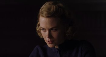 Movie still from “The Others” (2001), directed by Alejandro Amenábar – A woman with blonde curly hair is looking at the camera; Close Up shot, Over the shoulder angle