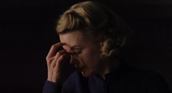 Movie still from “The Others” (2001), directed by Alejandro Amenábar – A woman is holding her hand to her face; Close Up shot, High angle