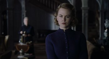 Movie still from “The Others” (2001), directed by Alejandro Amenábar – A woman standing in front of another woman; Medium shot, Low angle