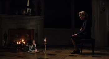 Movie still from “The Others” (2001), directed by Alejandro Amenábar – A woman sitting on the floor next to a little girl; Wide shot, High angle
