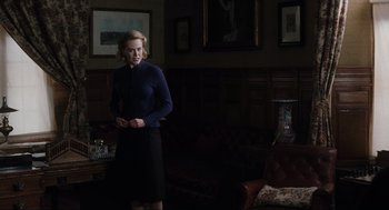 Movie still from “The Others” (2001), directed by Alejandro Amenábar – A woman standing in a dark living room; Medium shot, Over the shoulder angle