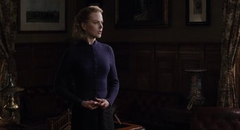 Movie still from “The Others” (2001), directed by Alejandro Amenábar – A woman standing in front of a wall with a painting; Medium shot, Low angle