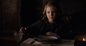 Movie still from “The Others” (2001), directed by Alejandro Amenábar – A girl sitting at a table with a bowl of soup; Close Up shot, Over the shoulder angle