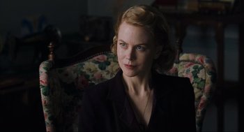 Movie still from “The Others” (2001), directed by Alejandro Amenábar – A woman sitting on a couch in a living room; Close Up shot, Over the shoulder angle