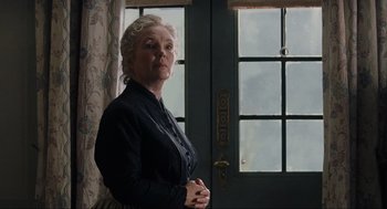 Movie still from “The Others” (2001), directed by Alejandro Amenábar – An older woman standing in front of a door; Medium shot, Low angle