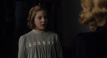 Movie still from “The Others” (2001), directed by Alejandro Amenábar – A young girl in a dress looking at a woman in a dress; Close Up shot, Over the shoulder angle
