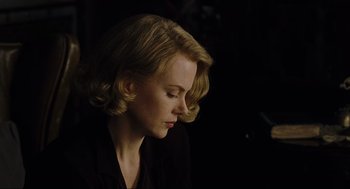 Movie still from “The Others” (2001), directed by Alejandro Amenábar – A woman with blonde hair is looking down at her face; Close Up shot, Over the shoulder angle