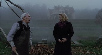 Movie still from “The Others” (2001), directed by Alejandro Amenábar – A man and a woman standing next to each other in front of a lake; Medium shot, Low angle