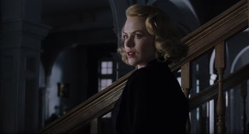 Movie still from “The Others” (2001), directed by Alejandro Amenábar – A woman with blonde curly hair leaning on a railing; Close Up shot, Low angle