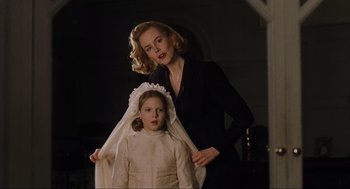 Movie still from “The Others” (2001), directed by Alejandro Amenábar – A woman and a girl in a white dress; Close Up shot, Low angle