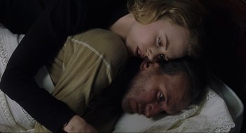 Movie still from “The Others” (2001), directed by Alejandro Amenábar – A man and a woman laying on the ground; Close Up shot, Overhead angle