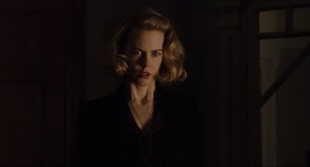 Movie still from “The Others” (2001), directed by Alejandro Amenábar – A woman with blonde hair wearing a black jacket; Close Up shot, Low angle