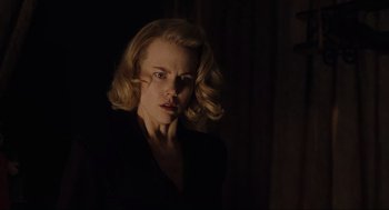 Movie still from “The Others” (2001), directed by Alejandro Amenábar – A woman with blonde hair is looking at the camera; Close Up shot, Low angle