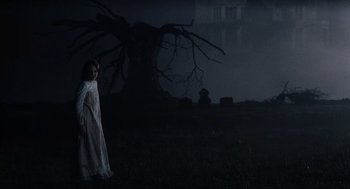 Movie still from “The Others” (2001), directed by Alejandro Amenábar – A woman in a white robe standing in a field; Wide shot, Low angle
