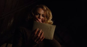 Movie still from “The Others” (2001), directed by Alejandro Amenábar – A woman holding an open book in front of her face; Close Up shot, Low angle