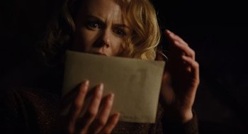 Movie still from “The Others” (2001), directed by Alejandro Amenábar – A woman holding an open envelope in front of her face; Close Up shot, Low angle