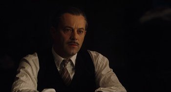 Movie still from “The Others” (2001), directed by Alejandro Amenábar – A man with a mustache wearing a vest and a tie; Close Up shot, Low angle