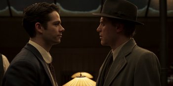 Movie still from “The Outfit” (2022), directed by Graham Moore – A couple of men standing next to each other; Close Up shot, Low angle