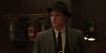 Movie still from “The Outfit” (2022), directed by Graham Moore – A man wearing a suit and a hat; Close Up shot, Low angle