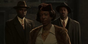 Movie still from “The Outfit” (2022), directed by Graham Moore – A group of men standing next to each other; Medium shot, Low angle