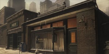 Movie still from “The Outfit” (2022), directed by Graham Moore – An image of a building that is in the middle of a city; Extreme Wide shot, High angle