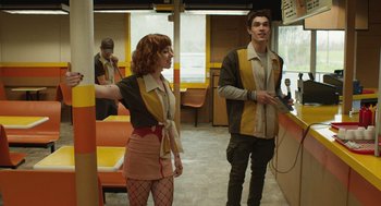 Movie still from “The Passenger” (2023), directed by Carter Smith – A man and a woman are playing a video game; Medium shot, Low angle