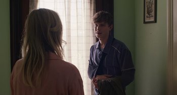 Movie still from “The Passenger” (2023), directed by Carter Smith – A man and a woman are talking in front of a window; Medium shot, Over the shoulder angle