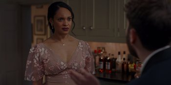 Movie still from “The People We Hate at the Wedding” (2022), directed by Claire Scanlon – A woman in a pink dress looking at a man in a black suit; Close Up shot, Over the shoulder angle