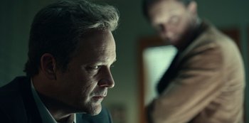 Movie still from “Dopesick” (2021), directed by Danny Strong – A person looking at the camera; Close Up shot, Over the shoulder angle