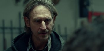 Movie still from “Dopesick” (2021), directed by Danny Strong – A person with long hair; Close Up shot, Over the shoulder angle