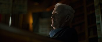 Movie still from “The Pigeon Tunnel” (2023), directed by Errol Morris – An older man sitting in front of a window; Close Up shot, Low angle