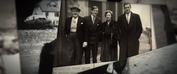 Movie still from “The Pigeon Tunnel” (2023), directed by Errol Morris – An old photo of a group of men and a woman; Medium shot, High angle