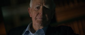 Movie still from “The Pigeon Tunnel” (2023), directed by Errol Morris – An old man with a white beard and a blue shirt; Close Up shot, Over the shoulder angle