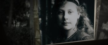 Movie still from “The Pigeon Tunnel” (2023), directed by Errol Morris – A black - and - white photo of a young girl; Extreme Close Up shot, High angle
