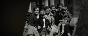 Movie still from “The Pigeon Tunnel” (2023), directed by Errol Morris – A black and white photo of a group of people; Medium shot, High angle