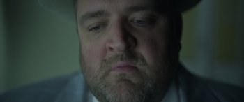 Movie still from “The Pigeon Tunnel” (2023), directed by Errol Morris – A person with a beard; Extreme Close Up shot, Low angle